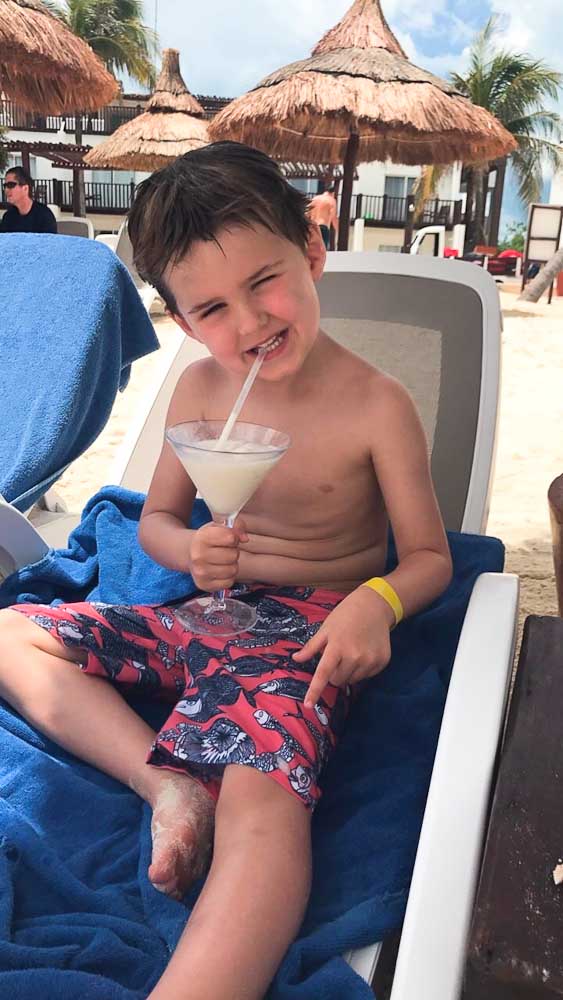 Luke enjoying a frozen drink on the beach at Club Med Cancun Yucatan
