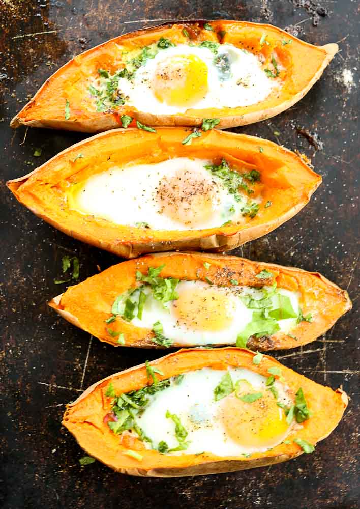 4 Baked Eggs with Spinach in a Sweet Potato Boat on a sheet pan
