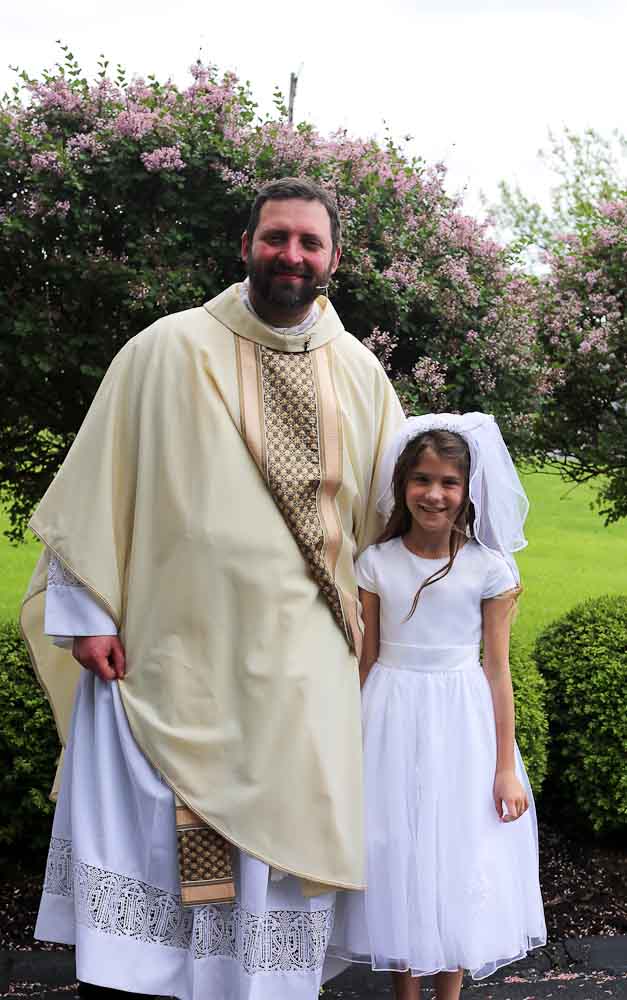 Meghan with Father Brian First communion weekend