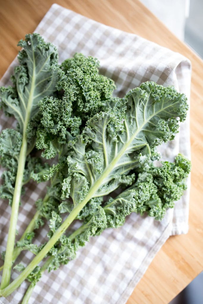 raw kale on a checked towel