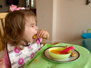 Meghan dipping grilled cheese in soup