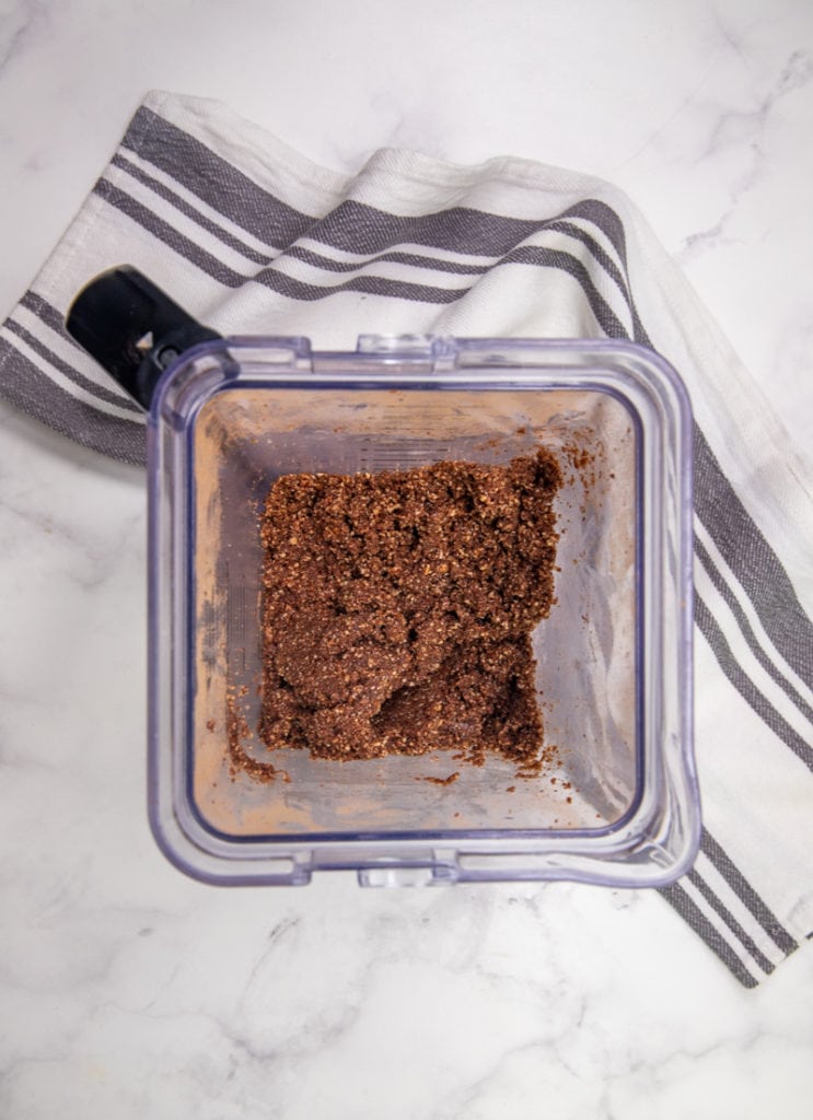 overhead shot of blender with crumb like texture of ingredients that have been processed