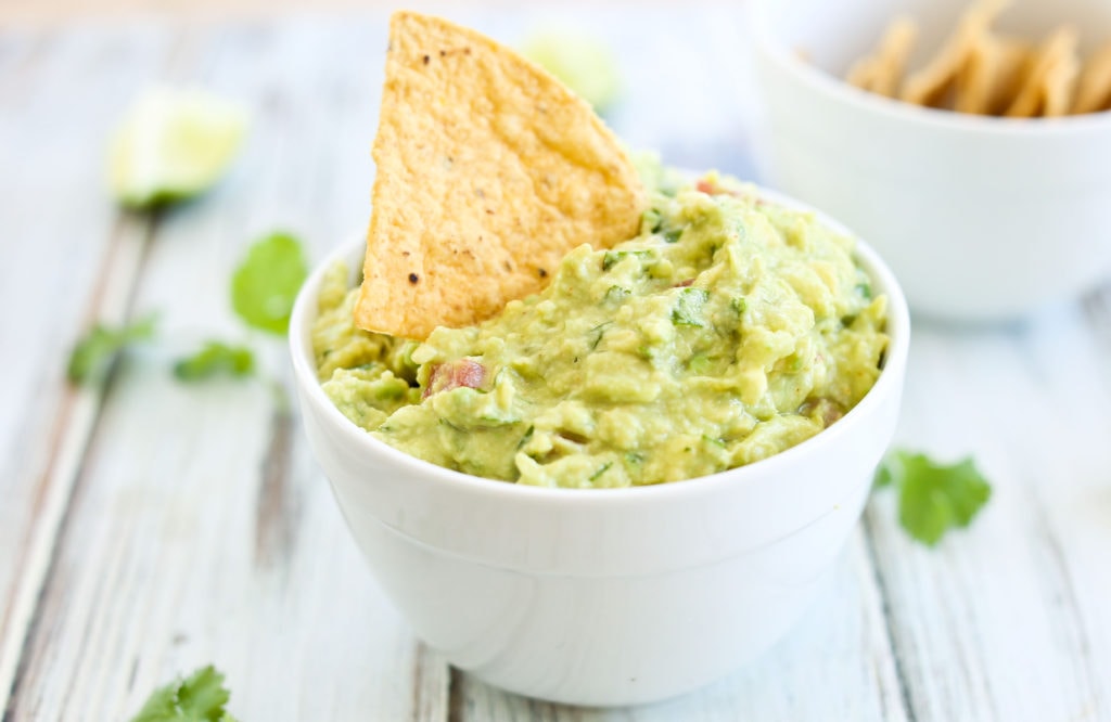 guacamole in a bowl with a chip