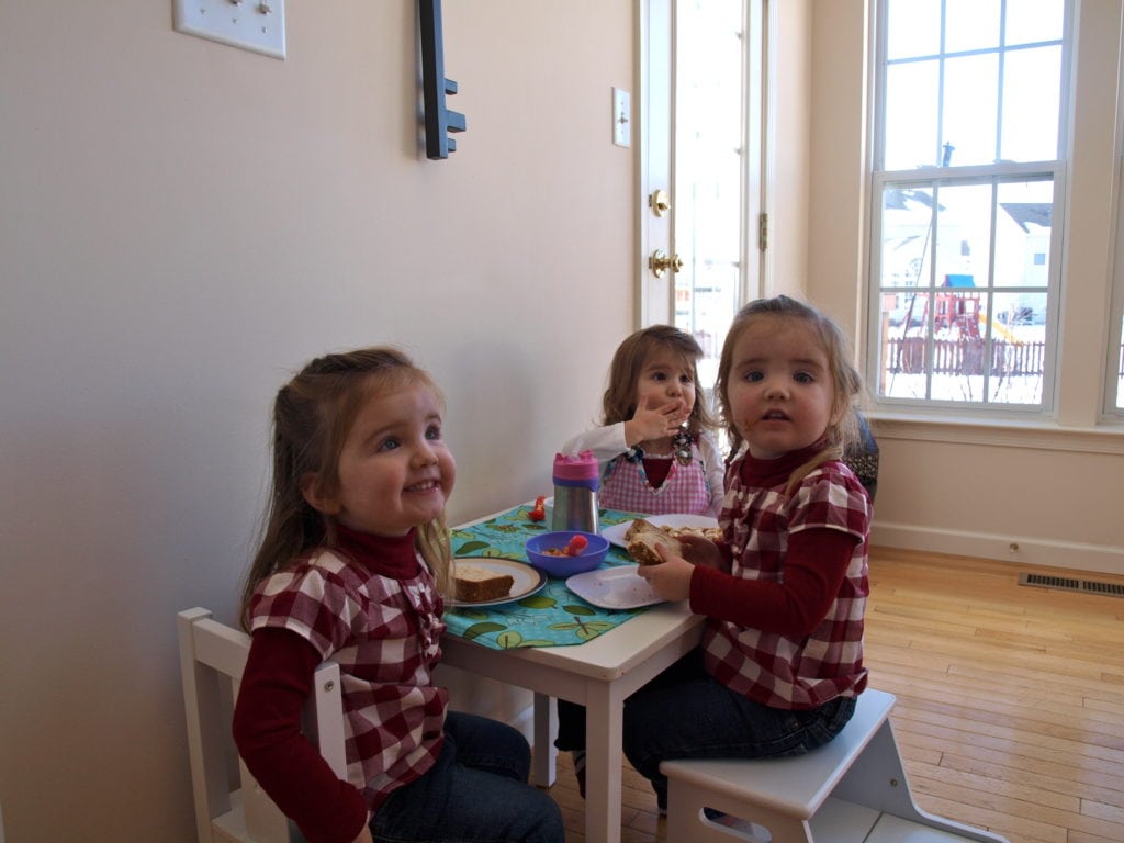 Meghan with her twin cousins eating alphabet soup