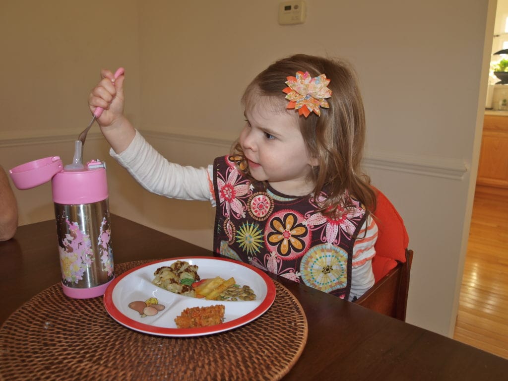 Meghan playing at dinner