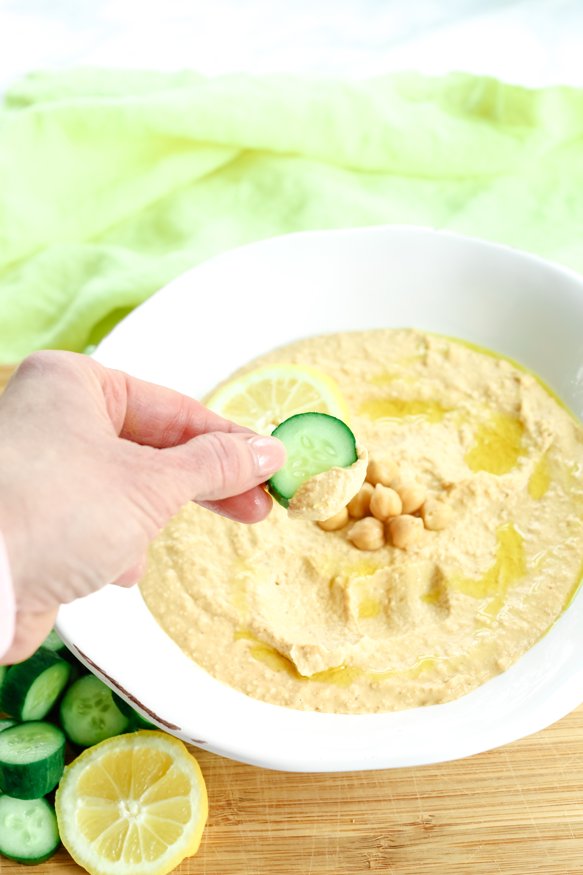 dipping a cucumber into the dip