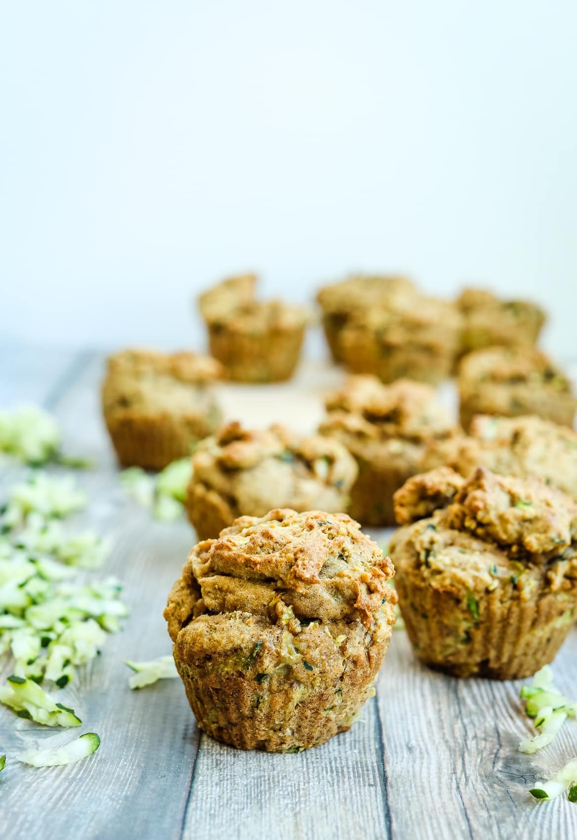 muffins surrounded by shredded zucchini