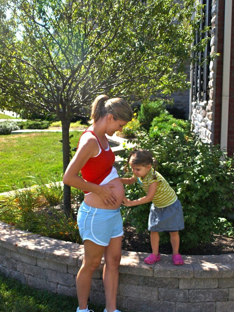 Meghan giving Baby Brother a kiss