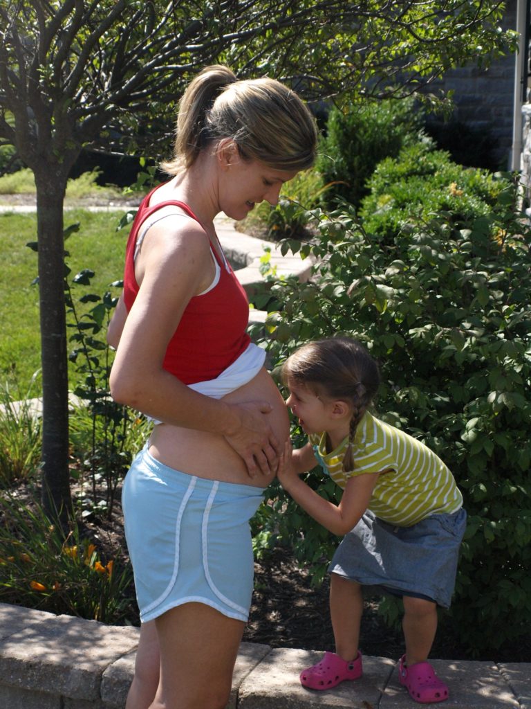 Meghan giving Baby Brother a kiss