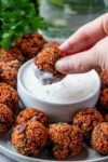 QUINOA PIZZA BALLS recipe dipping a ball in ranch dip