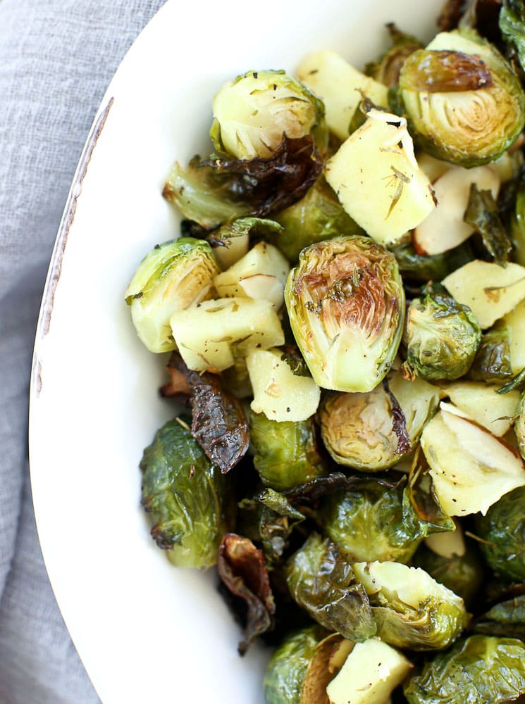 Roasted Brussels sprouts with apples and almonds in a white bowl recipe