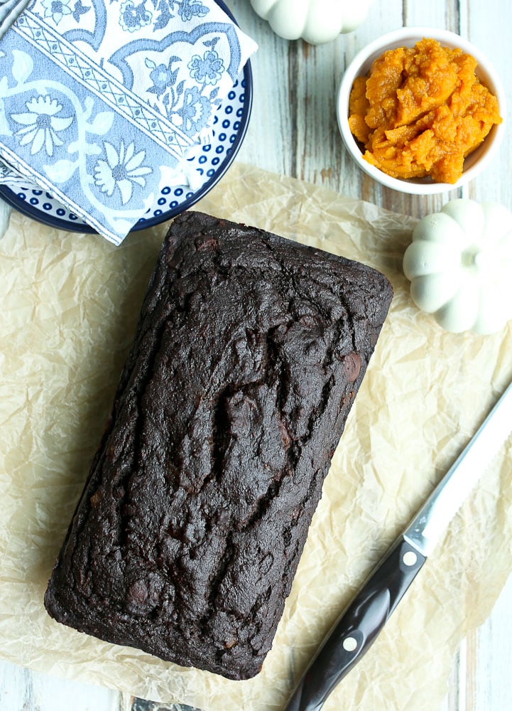 overhead shot of the whole Healthy Pumpkin Molasses Quickbread recipe with knife and blue napkins