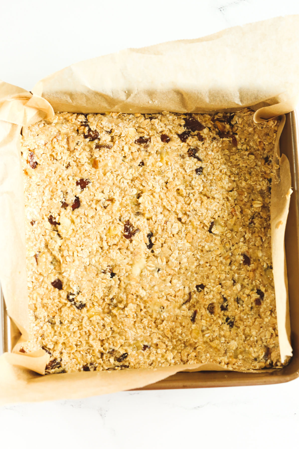 pan with pressed down oat mixture ready to bake