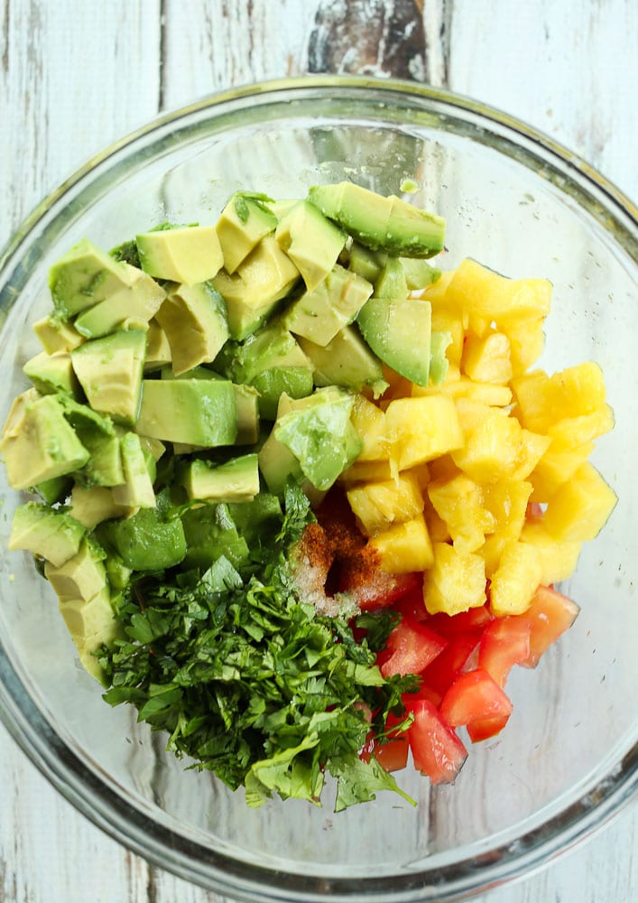 ingredients for pineapple avocado salsa in a bowl