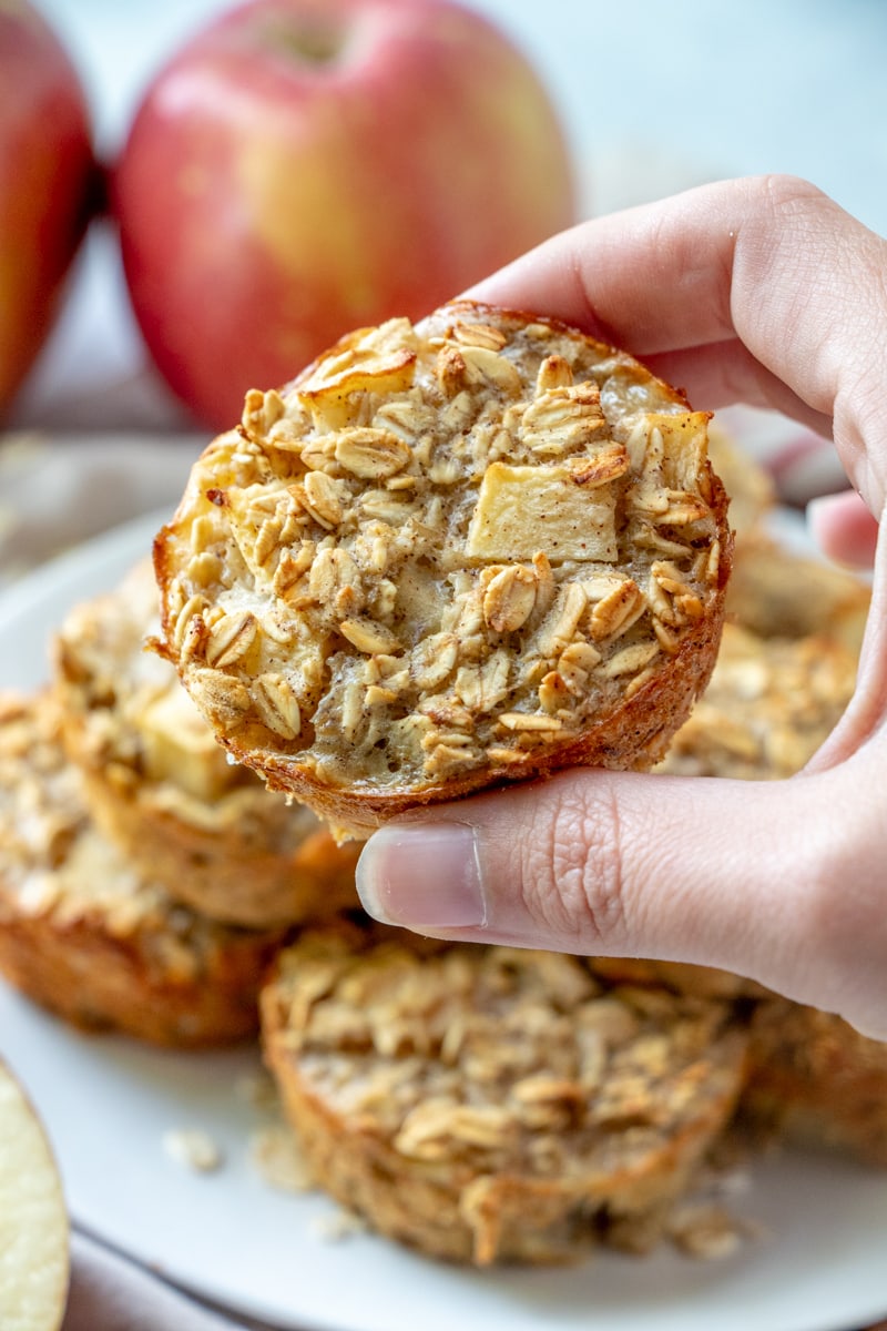 Apple Cinnamon Baked Oatmeal Cups Recipe holding one in hand