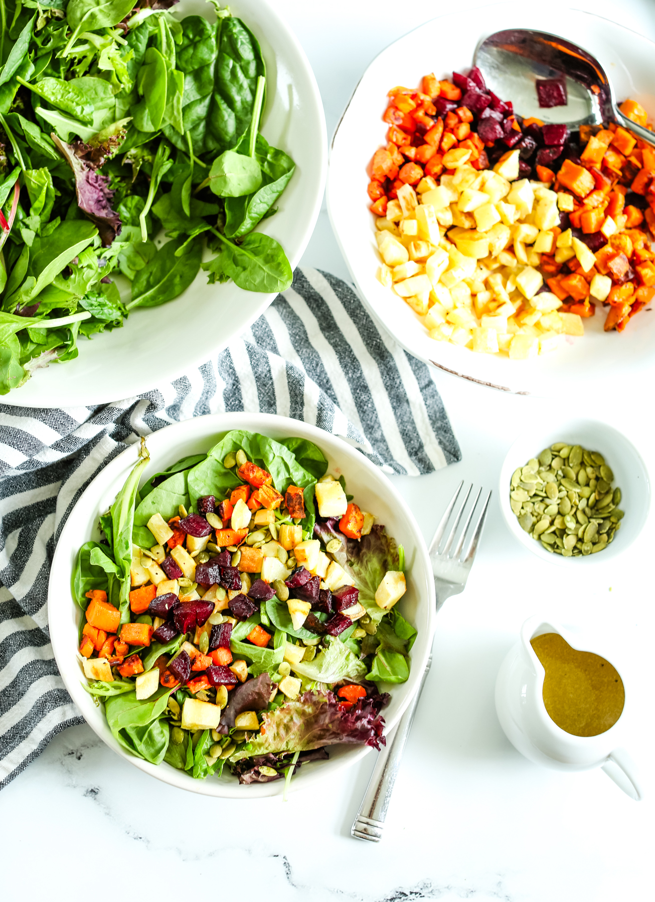 overhead shot of a salad with ingredients in separate bowls