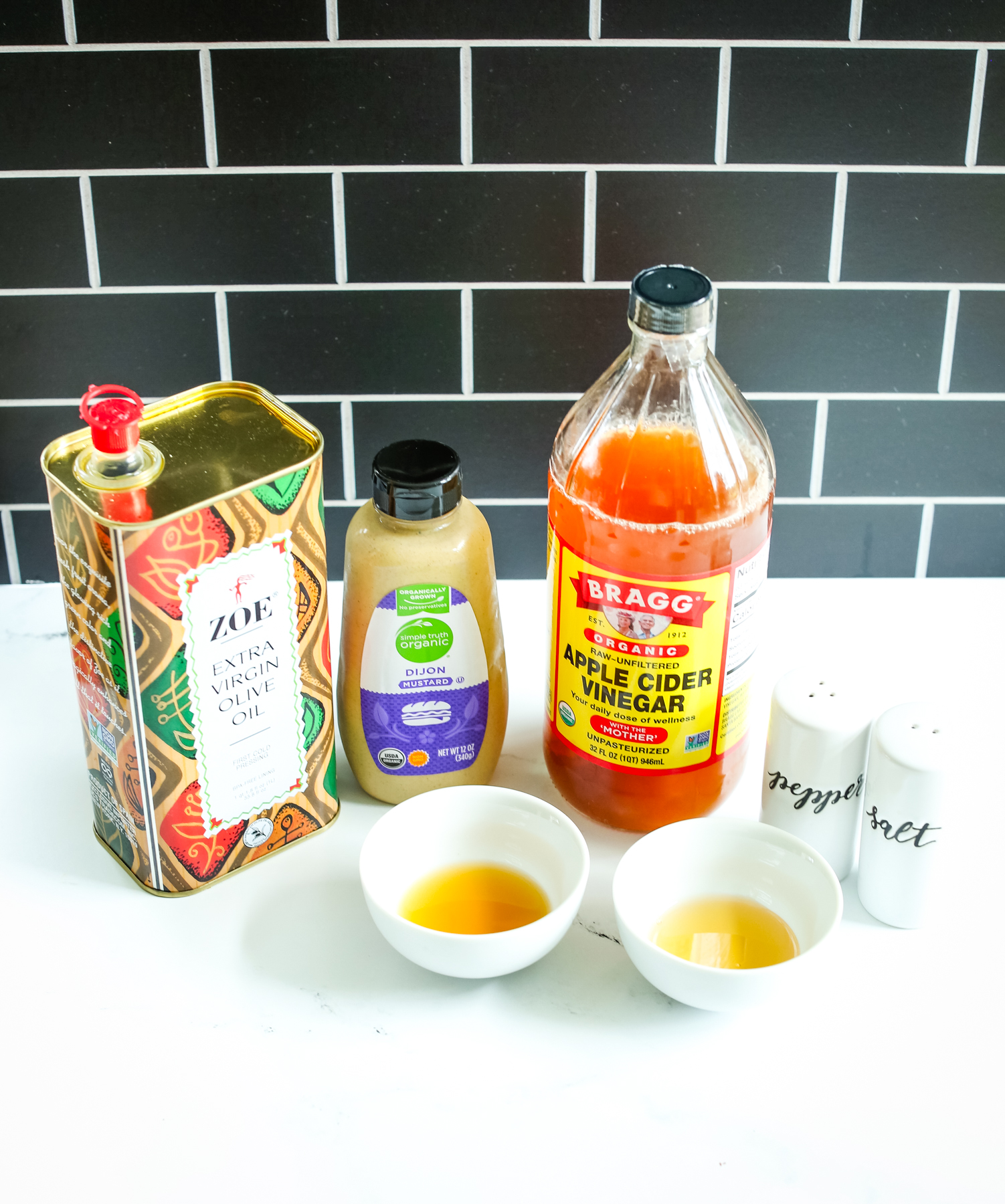 dressing ingredients--olive oil, apple cider vinegar, mustard, salt, and. pepper