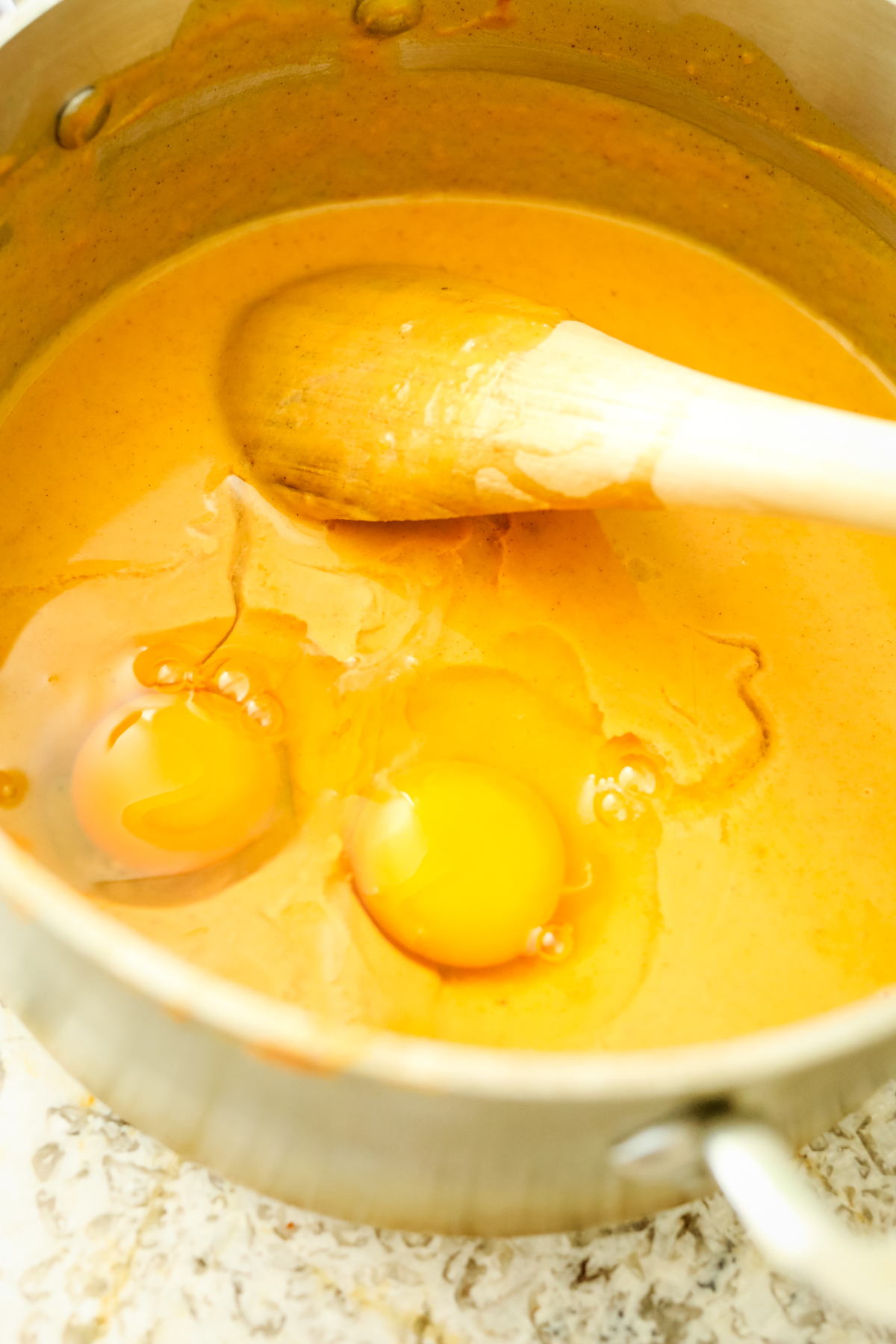 adding eggs to sweet potato mixture
