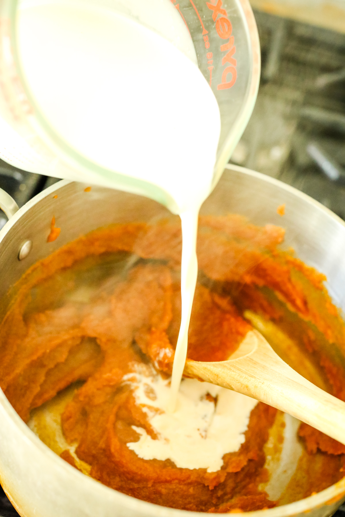 pouring milk into sweet potato mixture