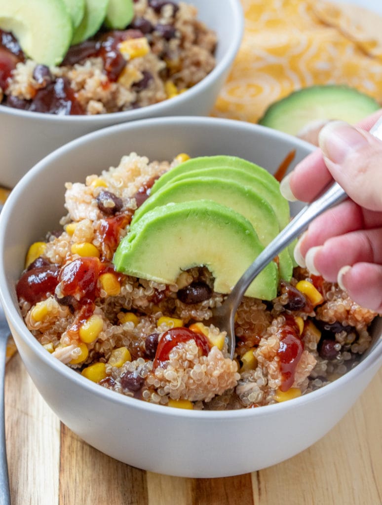 BBQ Chicken QUINOA BOWLS recipe in bowl with spoon and hand