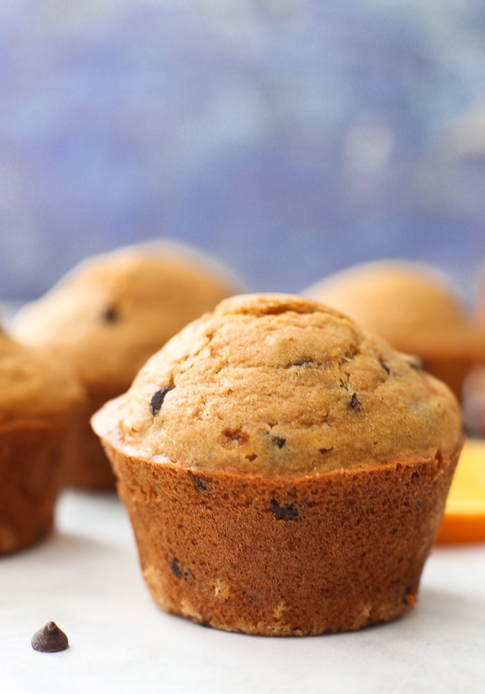 Orange Chocolate Chip Muffins-one muffin with others in the background healthy muffin recipe