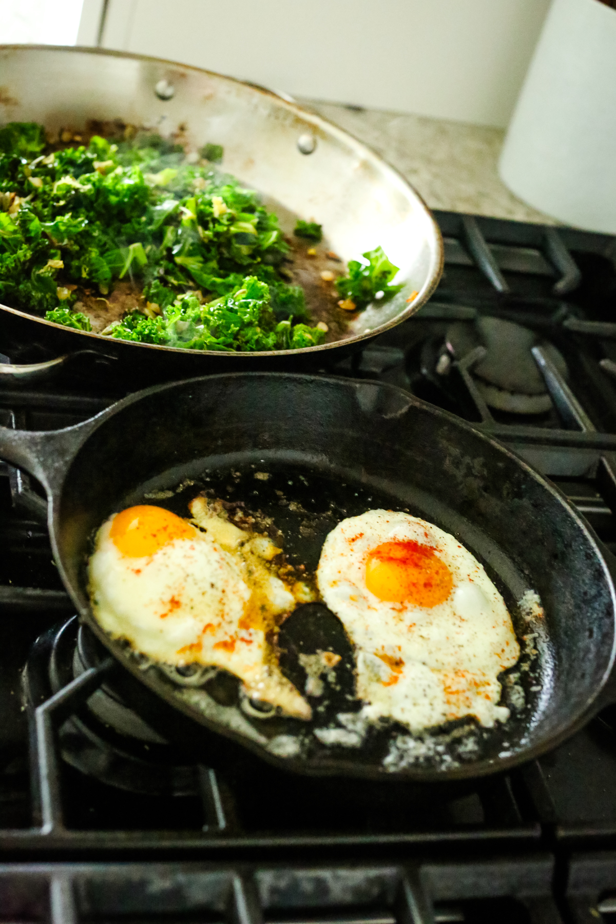 kale and eggs cooking on the stovetop