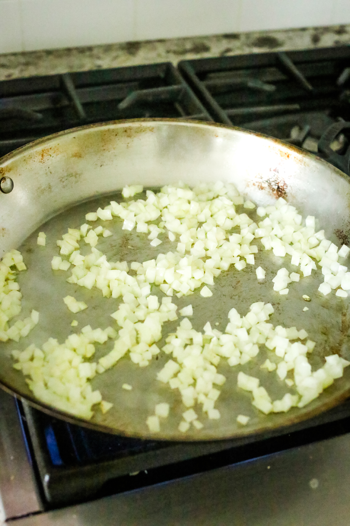 diced onions cooking in a large skillet