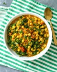 overhead shot of Lentil curry bowl with a green striped napkin and gold spoon