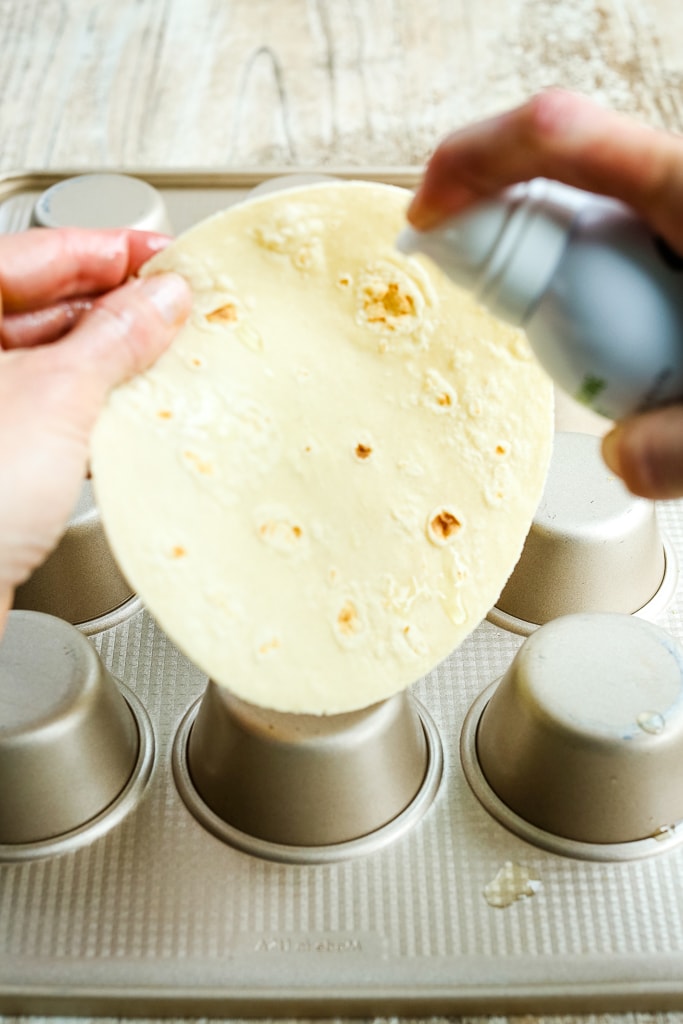 spraying a tortilla with avocado oil
