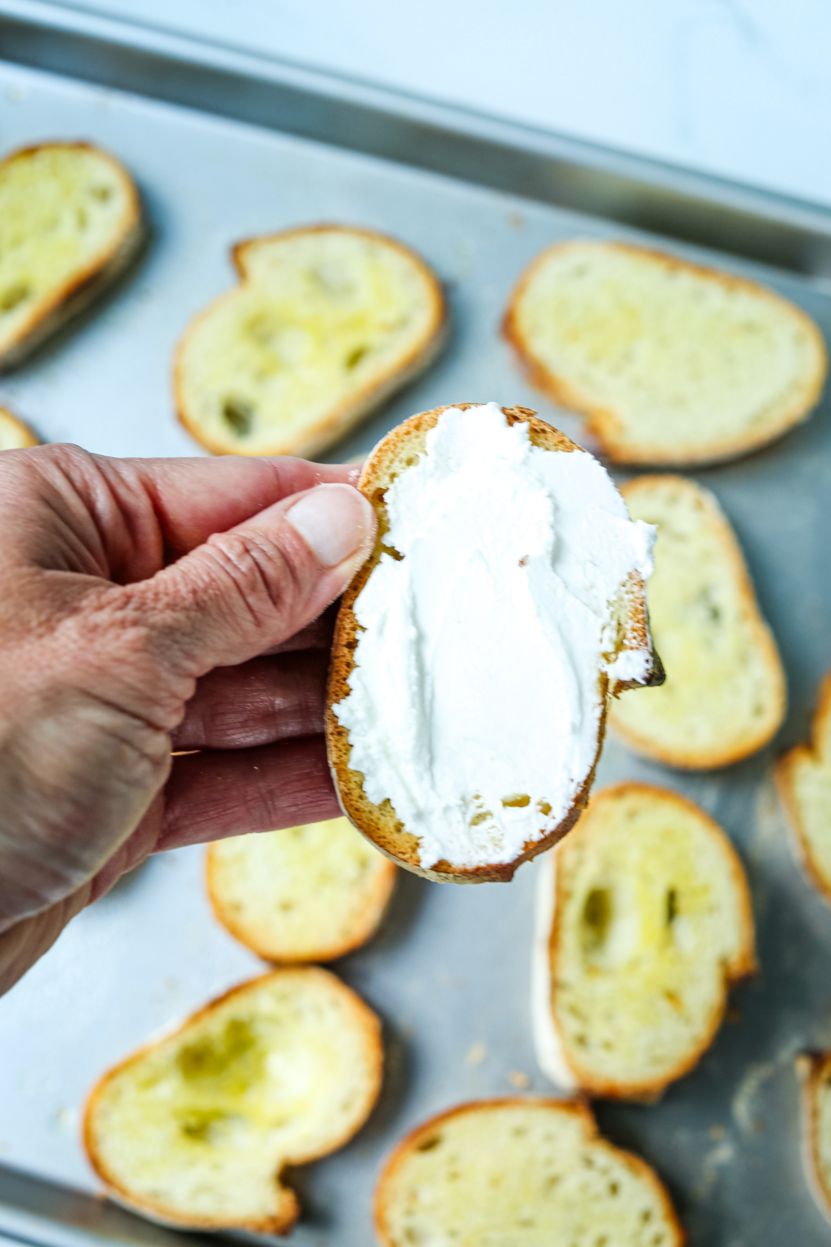 a small slice of bread spread with goat cheese