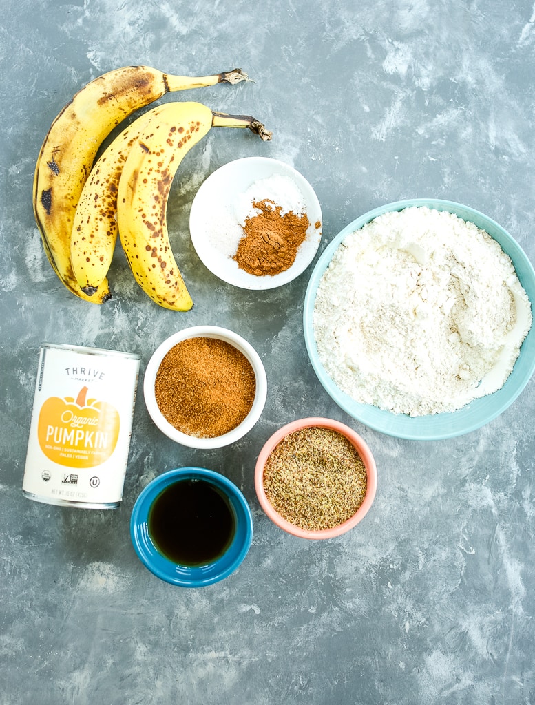 ingredients overhead shot: bananas, flour, sugar, maple syrup, pumpkin, spices flaxseed