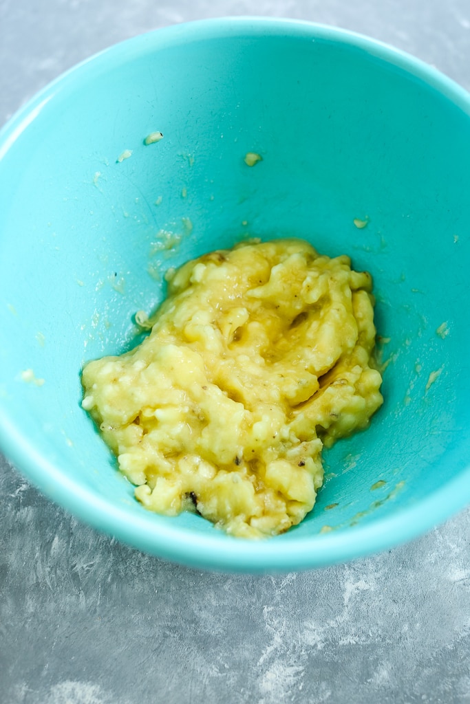 mashed banana in a blue bowl