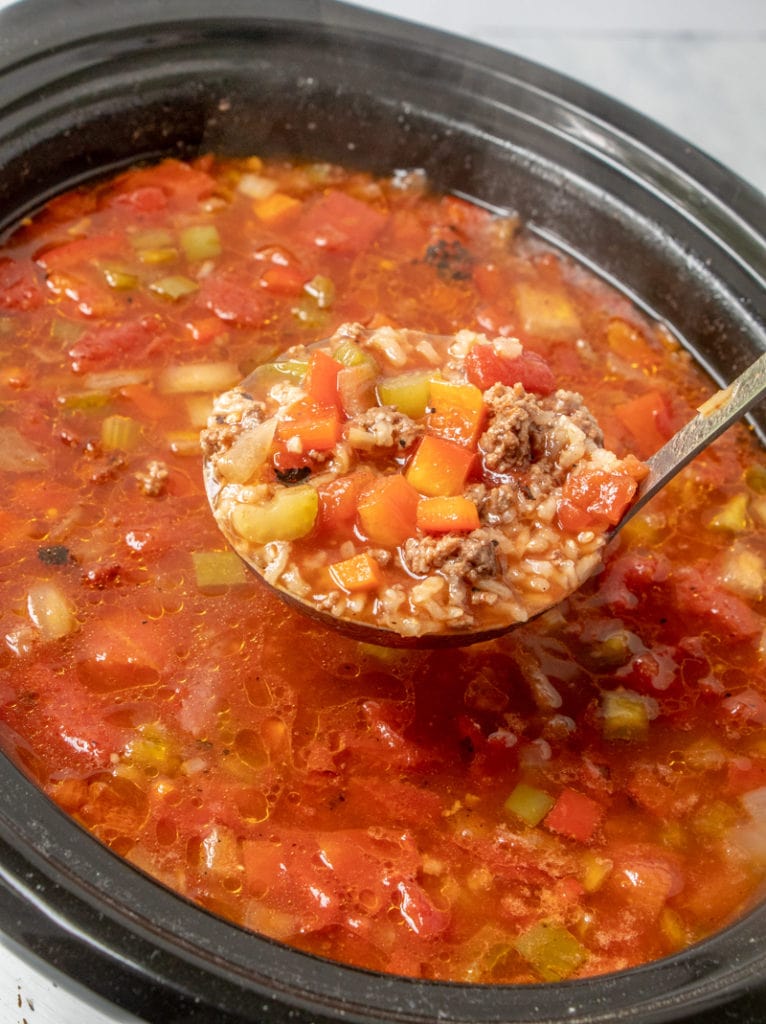SLOW COOKER STUFFED PEPPER SOUP recipe ladling a serving from crockpot