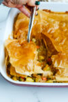 A corner being scooped out of Leftover Turkey Pot Pie