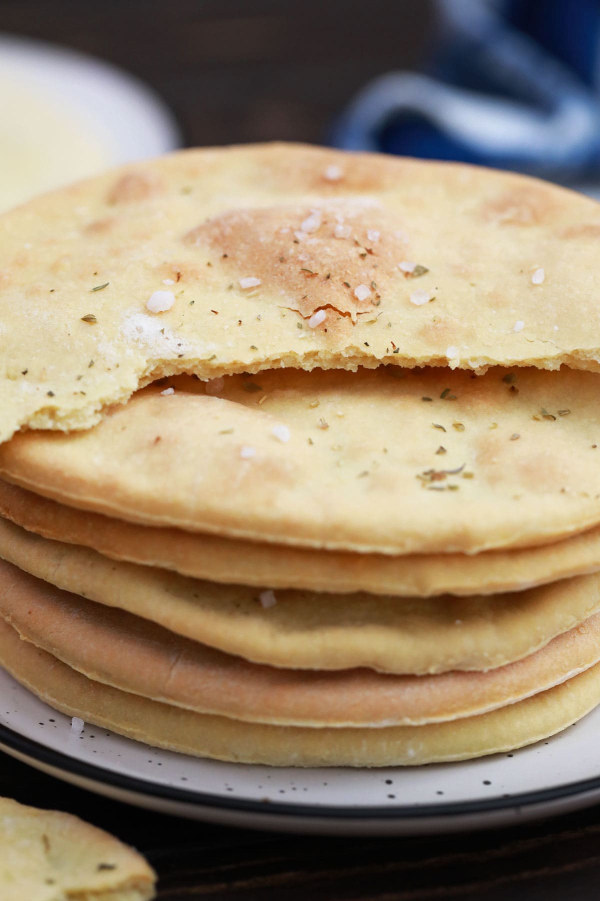 a stack of flatbread rounds with the top piece broken