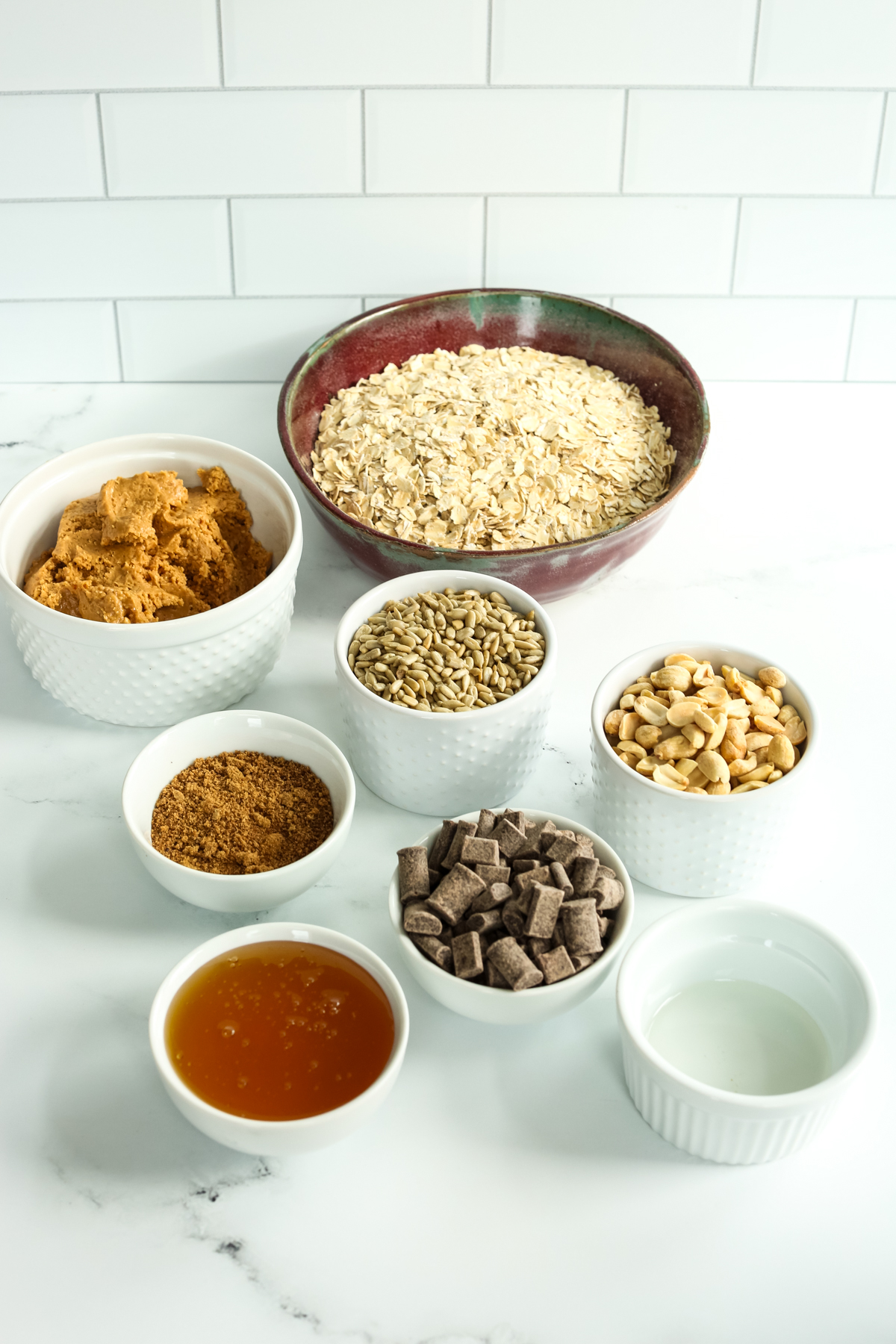 Ingredients for peanut butter granola in separate bowls