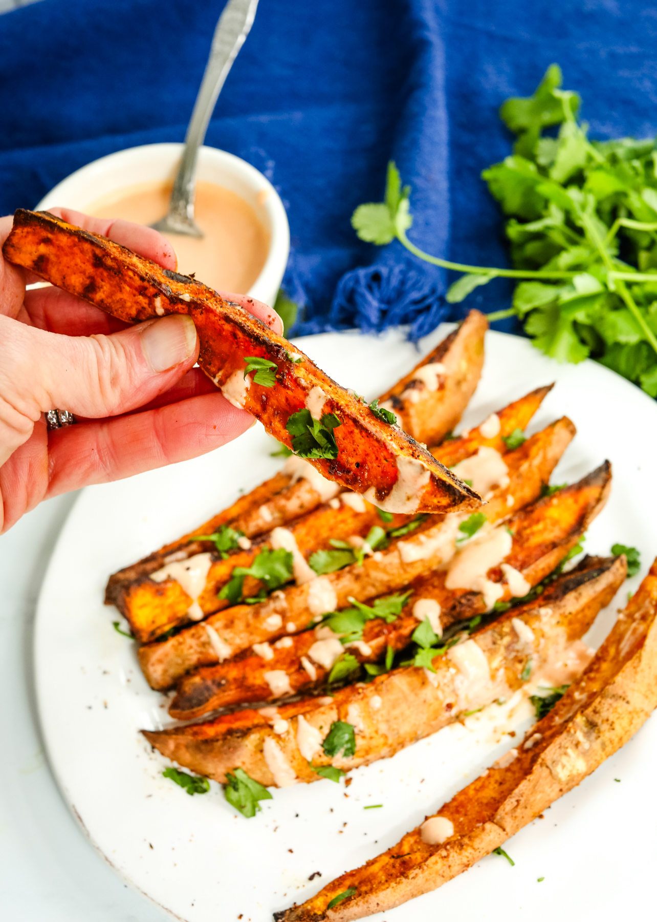sweet potato wedges with sauce and cilantro