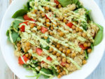 Spinach Salad with Quinoa, Crispy Chickpeas, Tomato, and Avocado Basil Dressing. A hearty, filling salad that can be a meal in itself! Easy healthy vegan recipe.