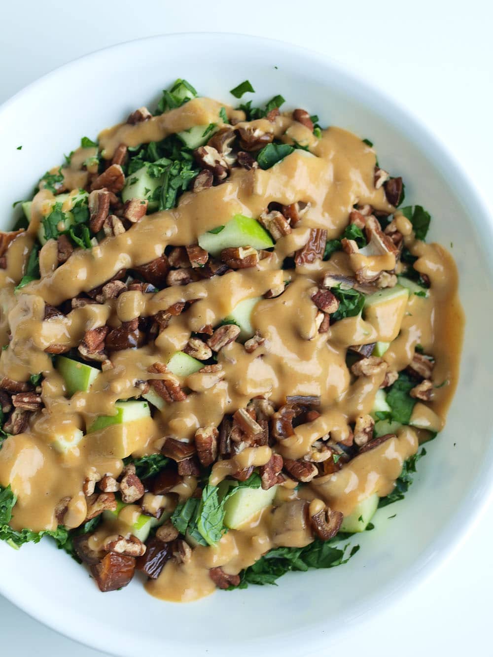 Autumn Kale Salad Recipe. This easy kale salad recipe will make your family beg them to serve them kale! The oil-free dressing is AMAZING. Gluten-free and vegan recipe.