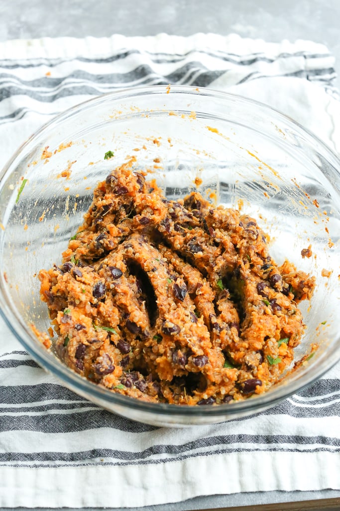 mashed ingredients (sweet potato, black beans, quinoa, and spices) in a glass bowl