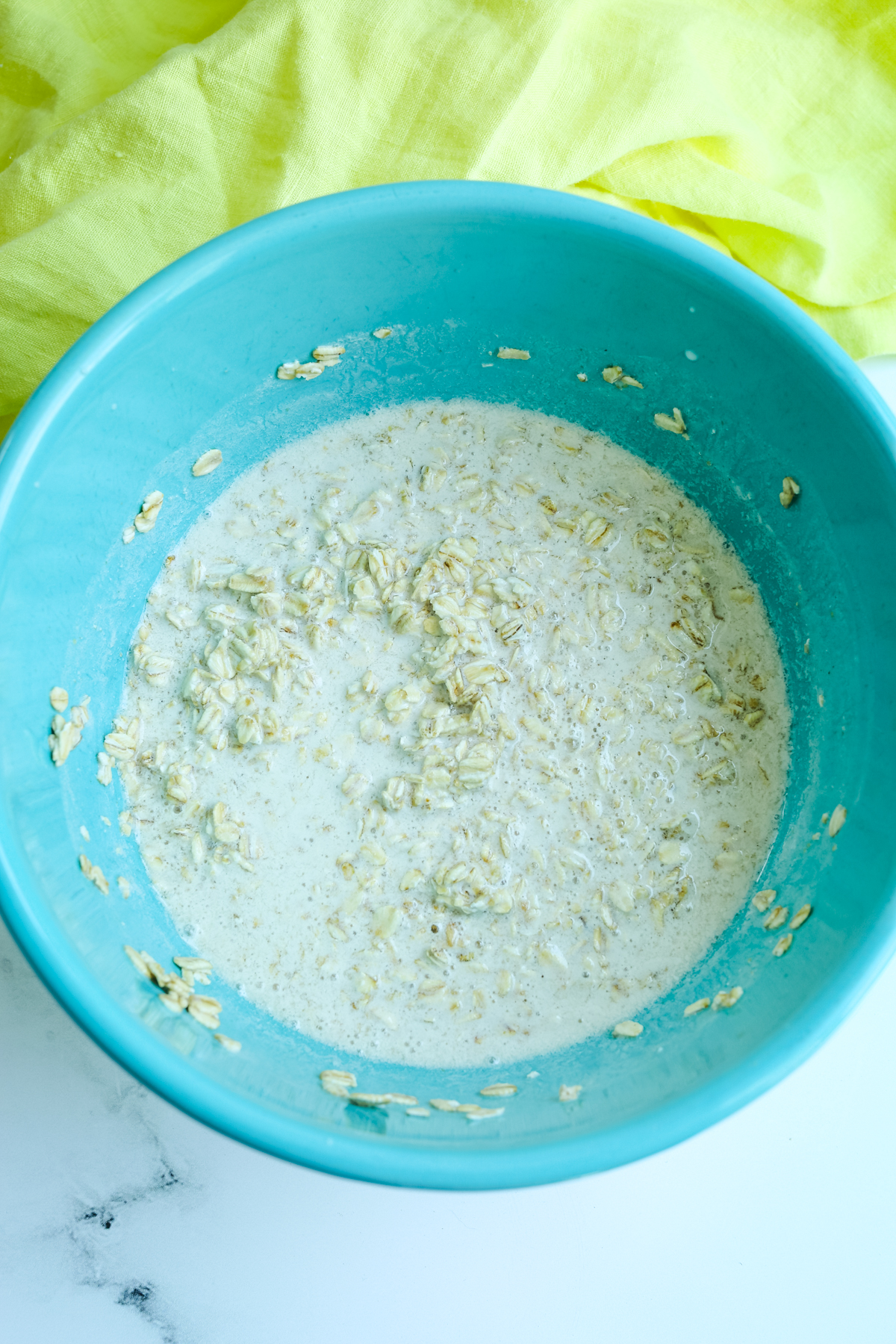 soaking oats and milk in a blue bowl