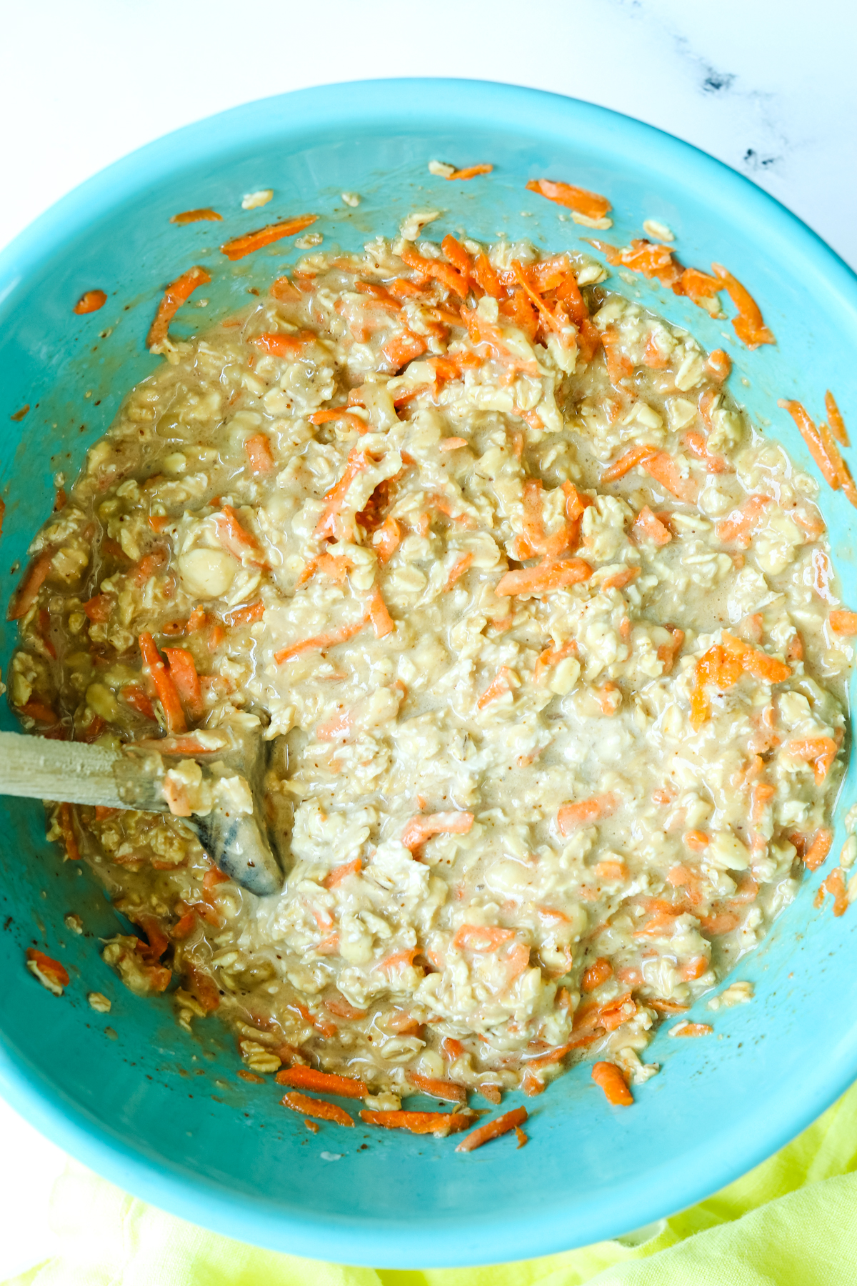 adding shredded carrots to the bowl 
