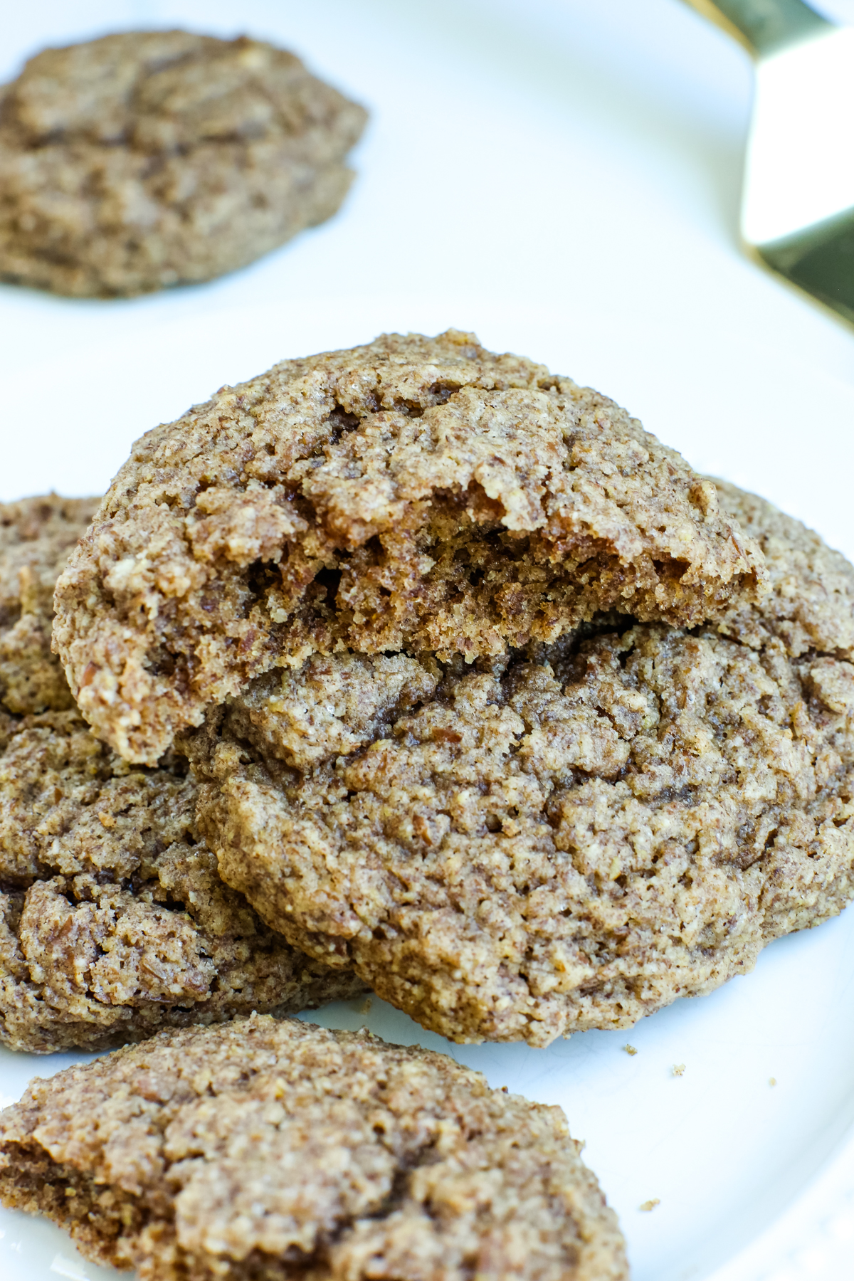 a stack of cookies with one broken in half on top