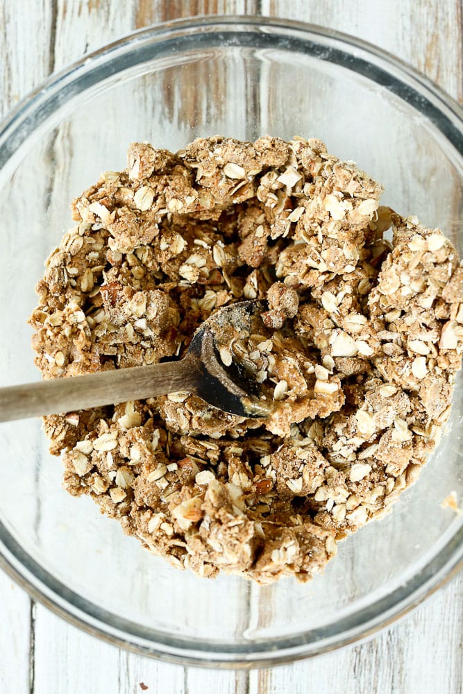 mixing oats and almond butter in a bowl