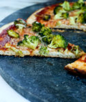 one piece of roasted broccoli barbecue pizza