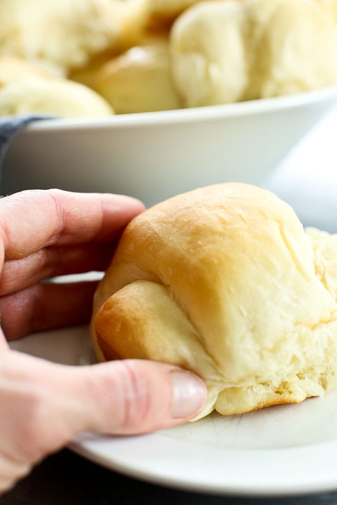 Perfect Bread Machine Dinner Rolls Recipe, hand grabbing a roll