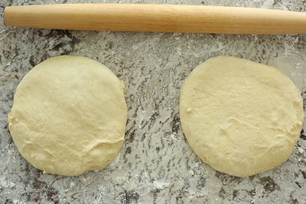 Perfect Bread Machine Dinner Rolls--two dough circles with a rolling pin