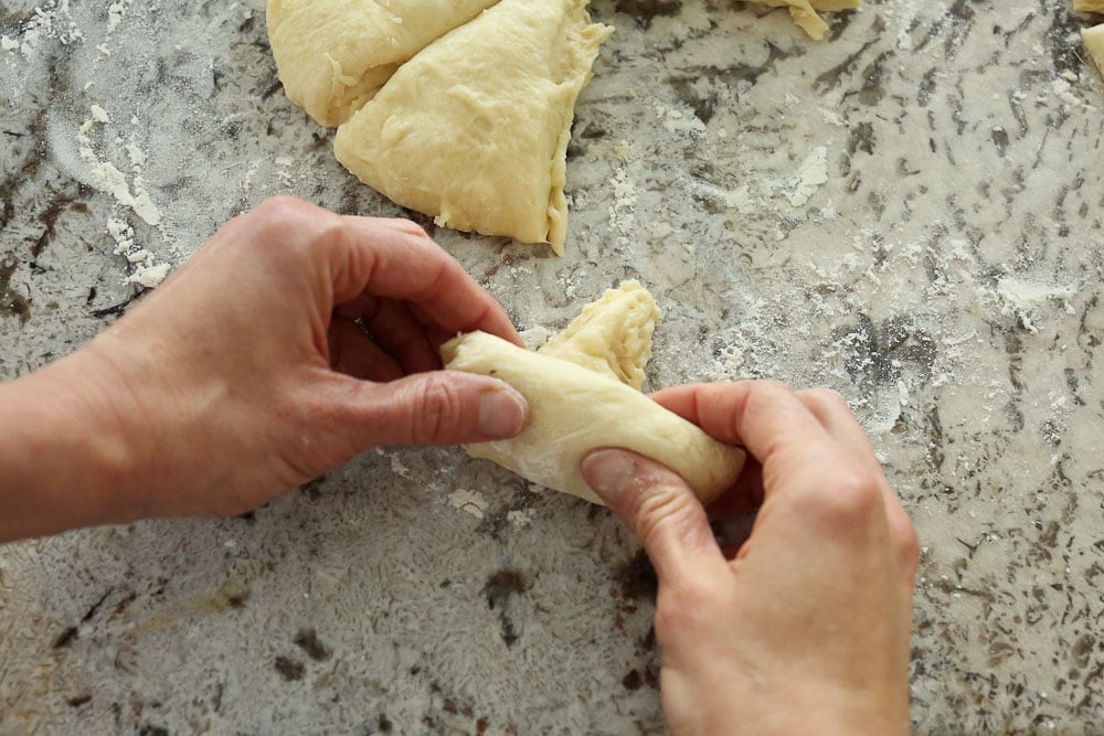 Perfect Bread Machine Dinner Rolls--rolling up the triangle into a crescent style roll