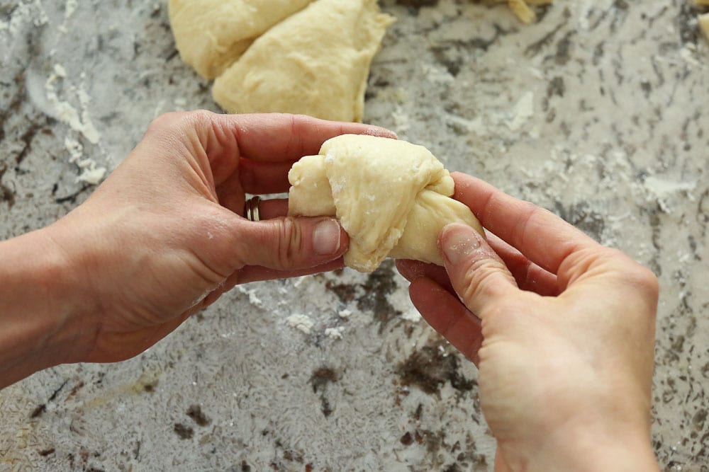 Perfect Bread Machine Dinner Rolls--rolling up the triangle into a crescent style roll-final shot