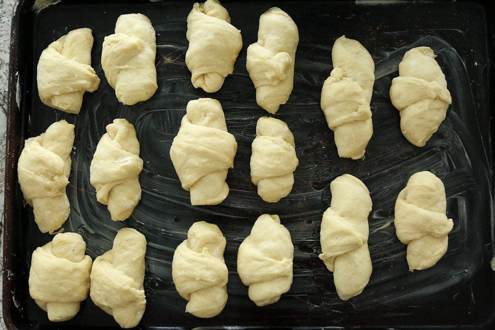 Perfect Bread Machine Dinner Rolls--crescent style rolls on a greased baking sheet